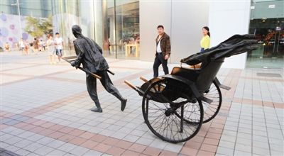 自由艺术家琴噶的作品《拉洋车》当年是王府井商业街最受游客欢迎的雕塑之一。这不是一个写实的雕塑，作者将车的拉杆特意断开，留给人以想象空间。 新京报记者 秦斌 摄