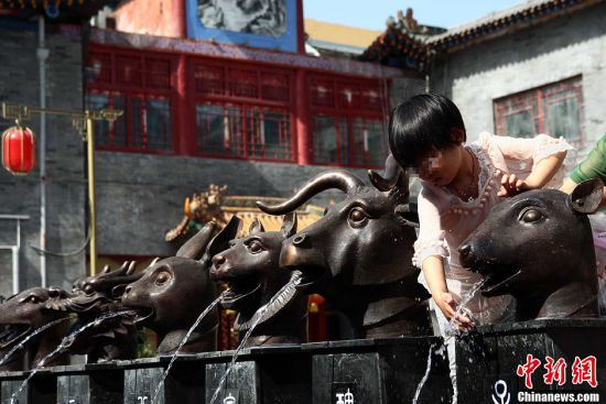 仿制的“圆明园十二兽首铜像”成孩童嬉水的玩具