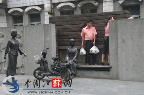 女子把这尊女生的雕像当靠背