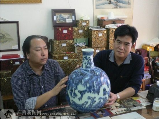 陈天宗（右）与邹永健在欣赏明代永乐年间的青花海水地百龙扁瓶。