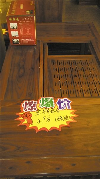 在某个红木展销会现场每件家具上面都有一个“惊爆价”标签。