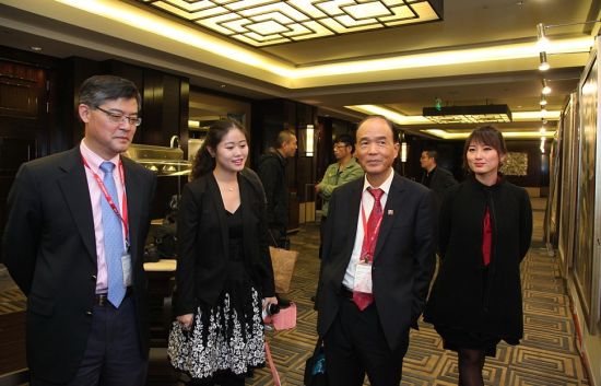 终审会委员许杰（左一）、曾宪章（左三）与英才奖（艺术）获得者在展览现场交流