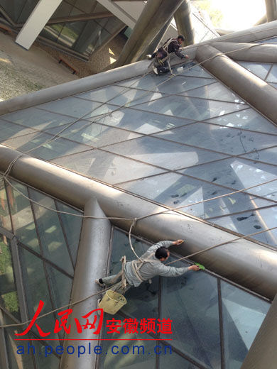 工人正对美术馆墙外面间隙进行修复