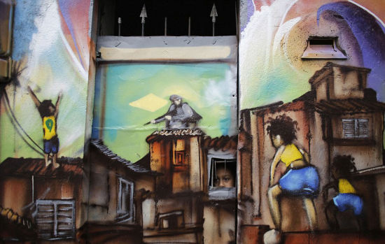 并非游戏：圣保罗贫民窟中一幅街头画显示，一名小男孩站在房顶上庆祝世界杯，与远处全副武装的男子遥遥相望。(网页截图)