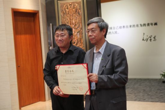 炎黄艺术馆馆长崔晓东先生向中国收藏家协会副秘书长张忠义先生颁发捐赠证书