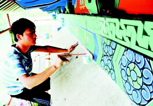 这是工作人员在复原颜庙古建筑上的彩绘图案。(资料片)　本报记者　李岩松　摄