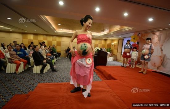 2013年10月27日，重庆市妇幼保健院，重庆孕妈彩绘大赛。准妈妈们高兴地上台走秀，与台下观众互动。摄影 渝友 SipaChina